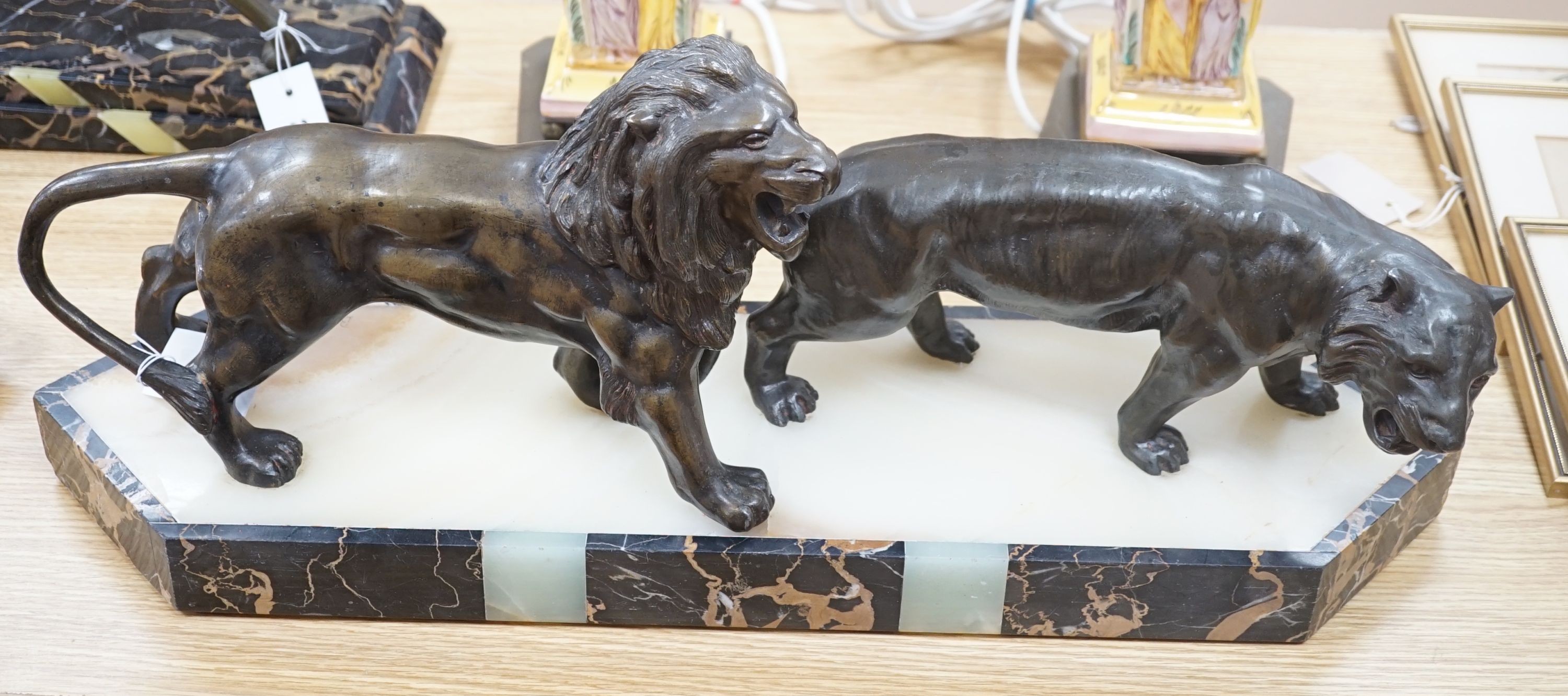 An Art Deco bronzed metal, marble and onyx group of lion and lioness, signed Benaca, 67cm
